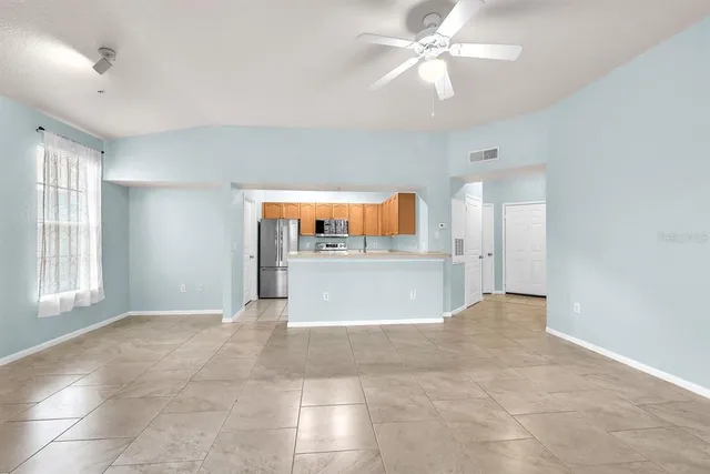 a view of a kitchen with a cabinet and a living room