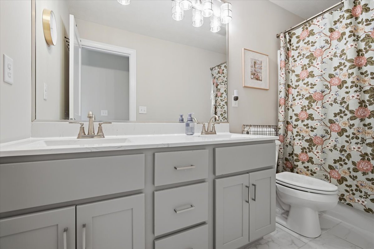 5407 Ferryman Road Bloomington, IL 61705 - Photo 17 of 61 a bathroom with a sink toilet and mirror