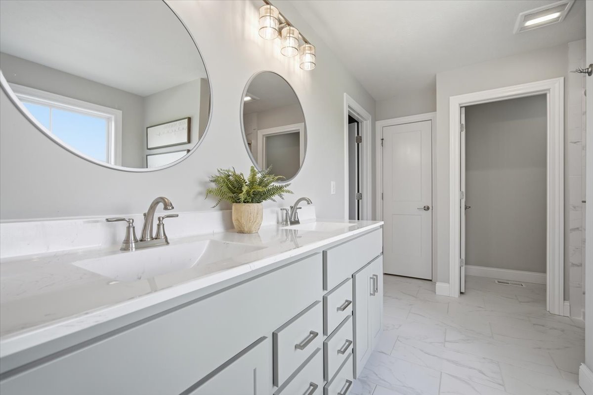 5407 Ferryman Road Bloomington, IL 61705 - Photo 23 of 61 a bathroom with a double vanity sink and a mirror
