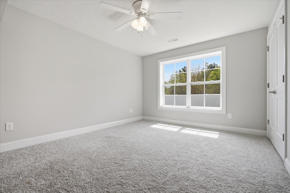 5407 Ferryman Road Bloomington, IL 61705 - Photo 27 of 61 an empty room with a window and a ceiling fan