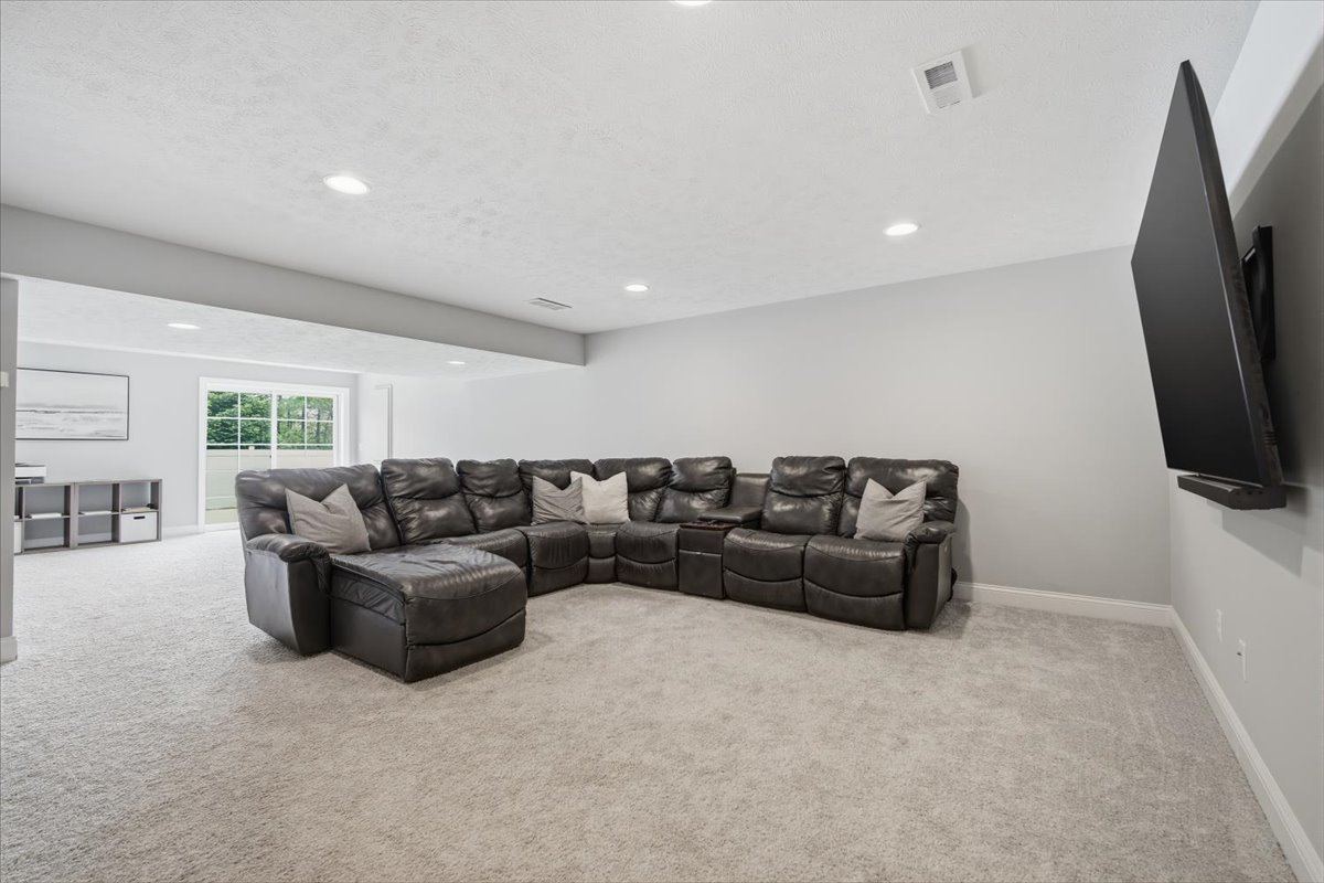 5407 Ferryman Road Bloomington, IL 61705 - Photo 35 of 61 a living room with furniture and a flat screen tv