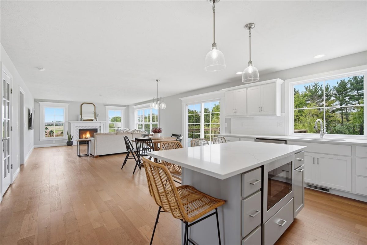 5407 Ferryman Road Bloomington, IL 61705 - Photo 9 of 61 a open kitchen with a table chairs and a wooden floor