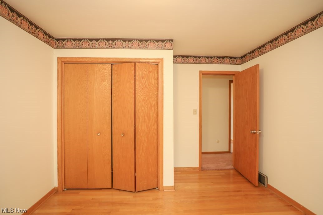 3143 Sandy Lake Road Ravenna, OH 44266 - Photo 29 of 35 Unfurnished bedroom featuring light hardwood flooring and a closet