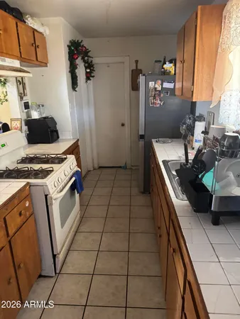 a kitchen with a sink a stove and refrigerator
