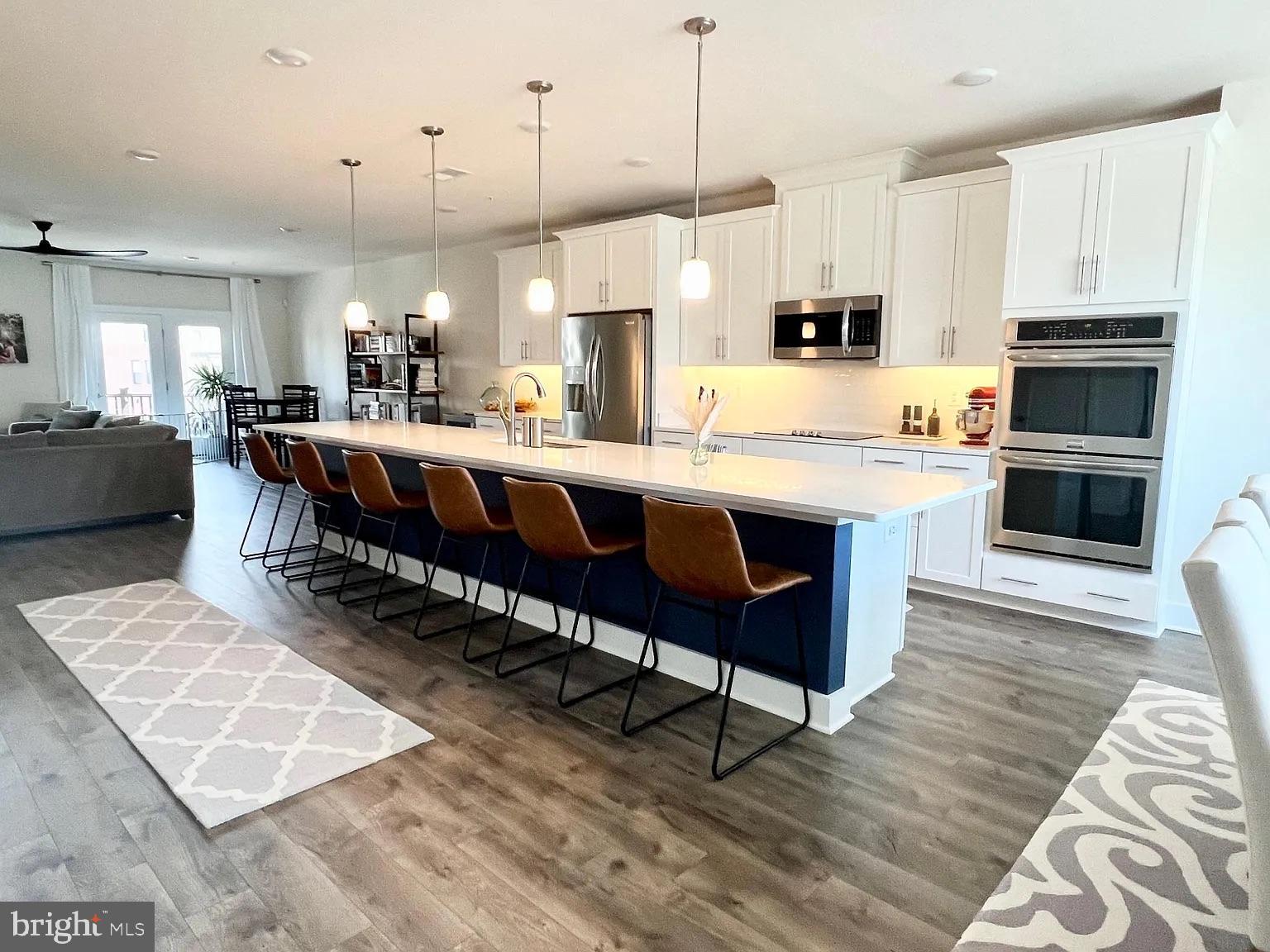 a large kitchen with a table and chairs