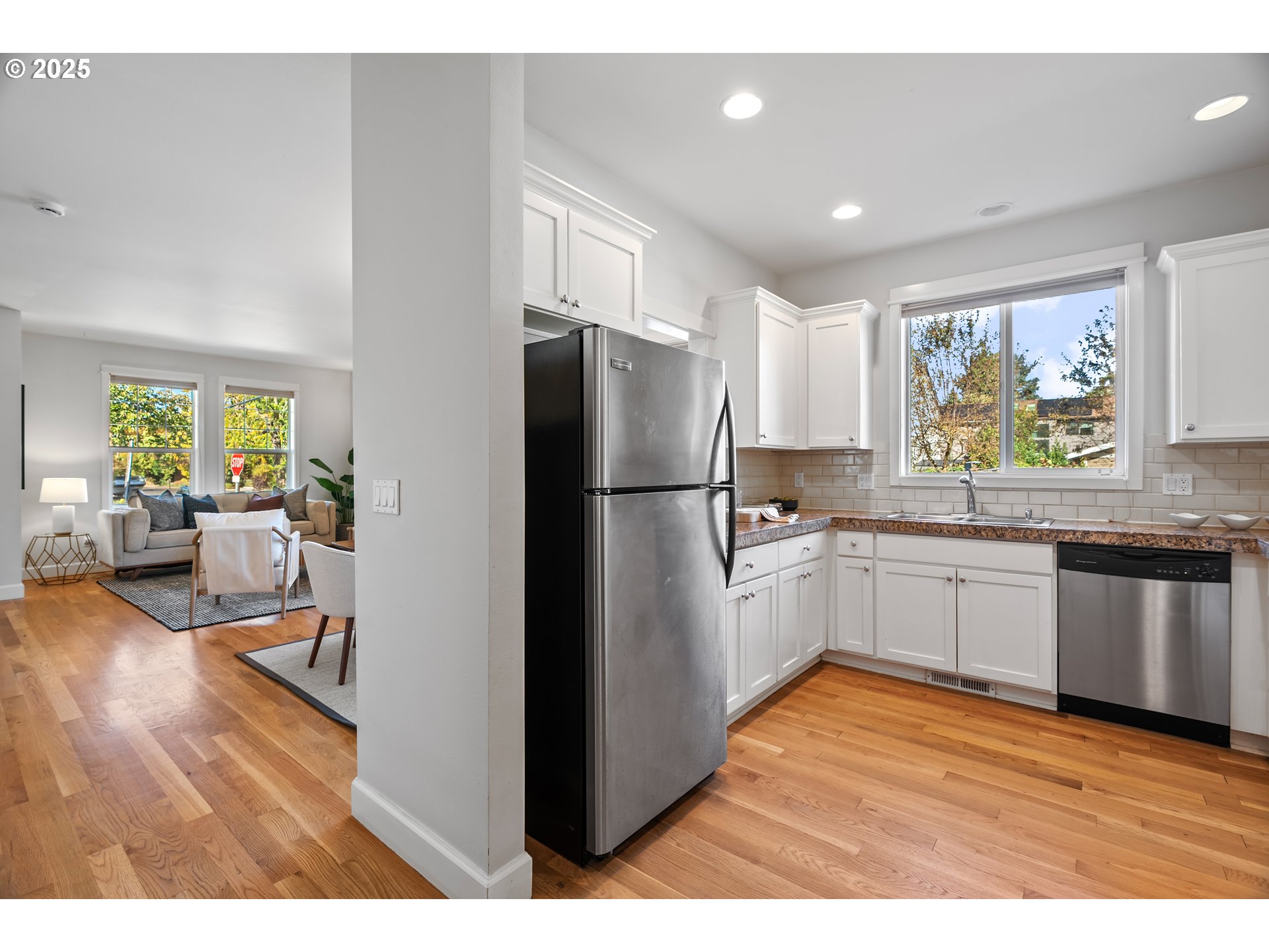 4646 North Commercial Avenue Portland, OR 97217 - Photo 12 of 31 a kitchen with stainless steel appliances granite countertop a refrigerator a sink dishwasher a stove with wooden floor