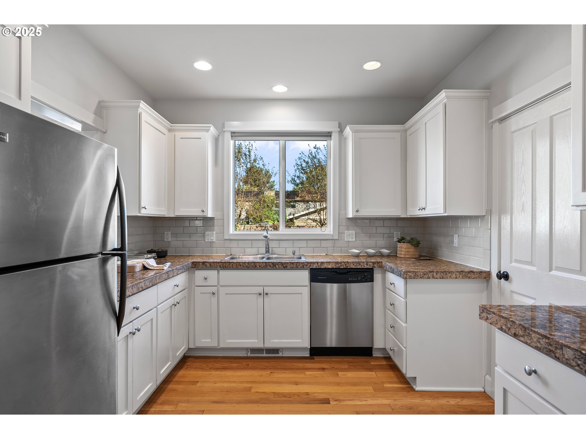 4646 North Commercial Avenue Portland, OR 97217 - Photo 13 of 31 a kitchen with a sink a refrigerator and window