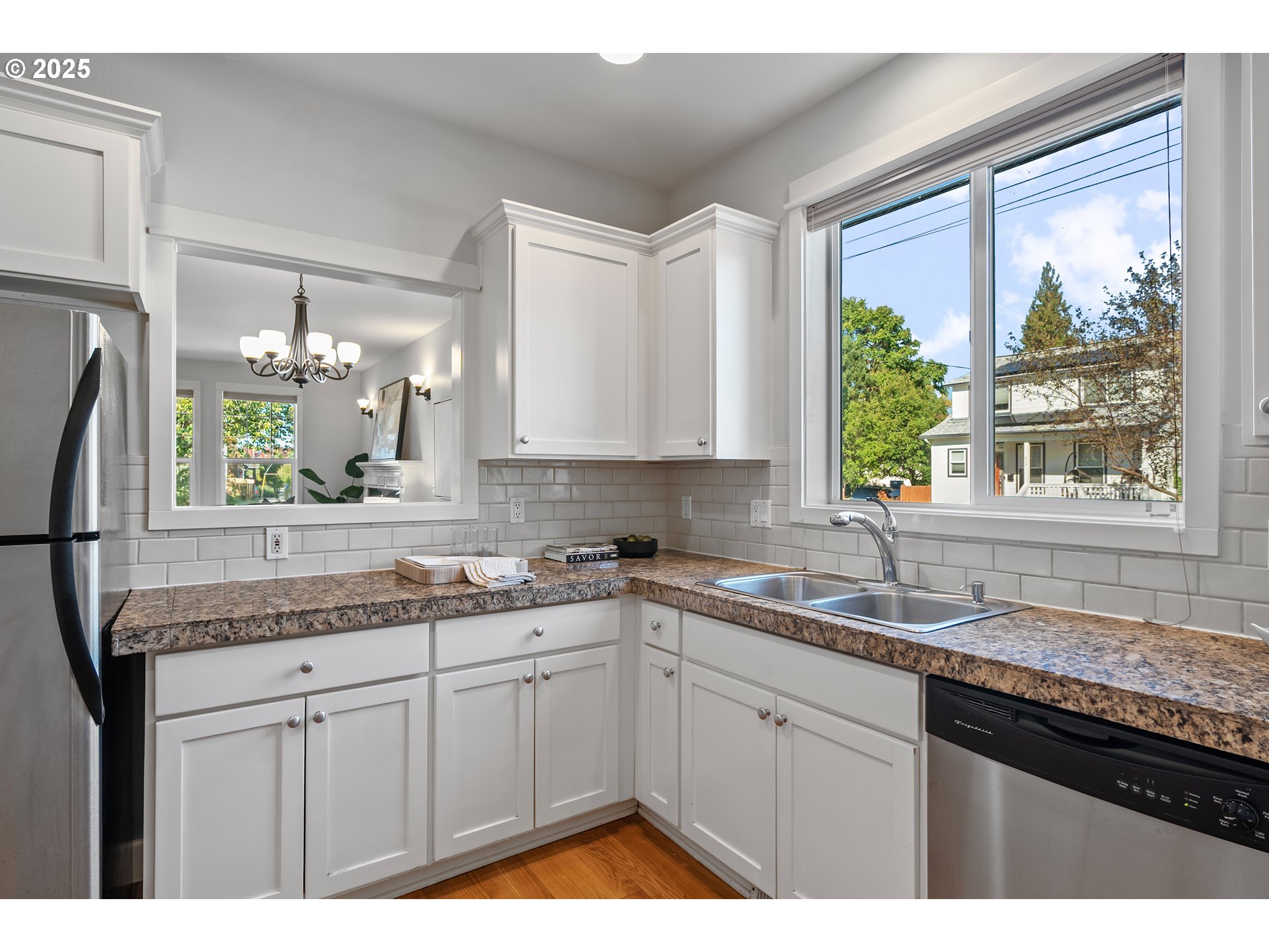 4646 North Commercial Avenue Portland, OR 97217 - Photo 14 of 31 a kitchen with a sink granite counter tops and a large window