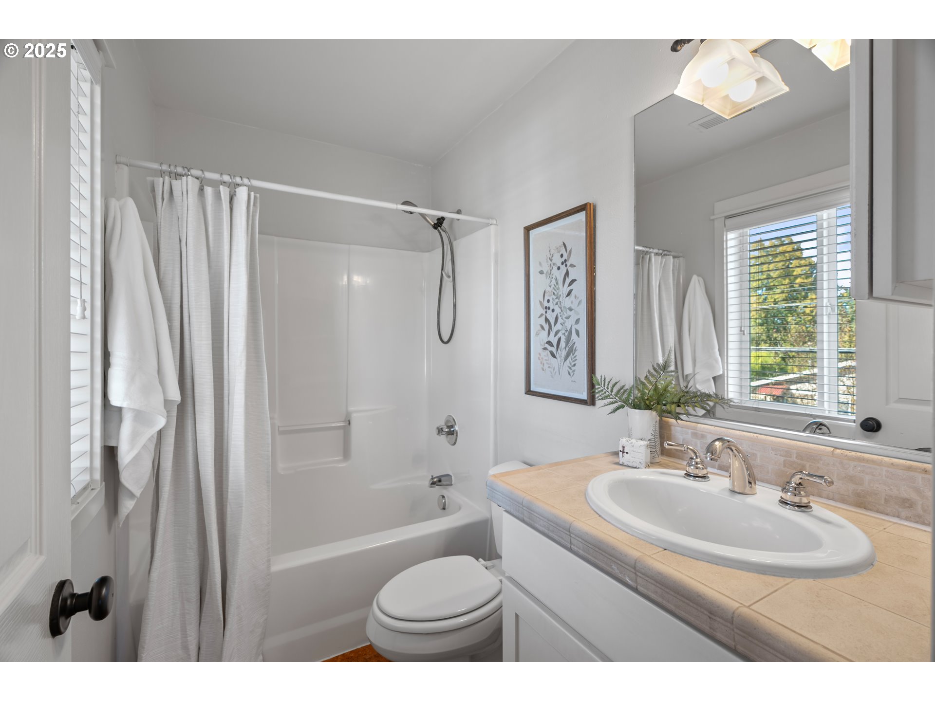 4646 North Commercial Avenue Portland, OR 97217 - Photo 21 of 31 a bathroom with a sink toilet a mirror and shower