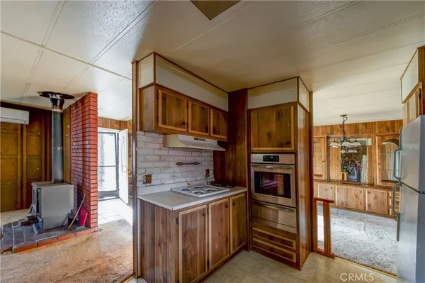 a kitchen with a refrigerator and a stove