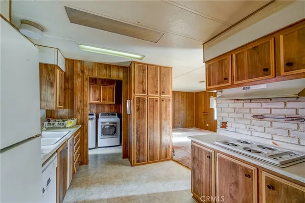 a kitchen with stainless steel appliances granite countertop a stove refrigerator and cabinets