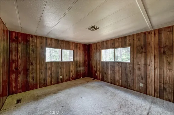 a view of a hallway with wooden walls