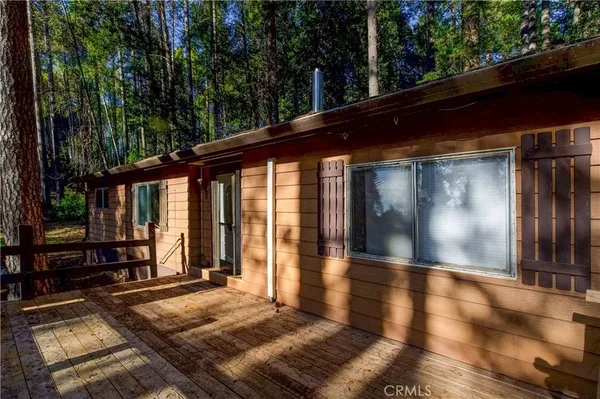 a view of backyard with wooden floor and large window