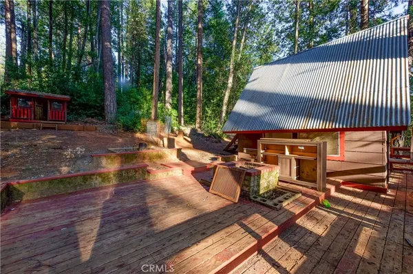 a view of a patio with table and chairs with wooden floor and fence