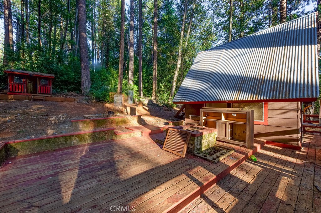 6613 Hupp Coutolenc Road Magalia, CA 95954 - Photo 4 of 20 a view of a patio with table and chairs with wooden floor and fence