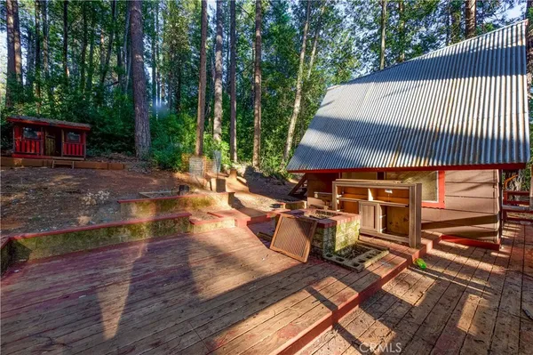 a view of a patio with table and chairs with wooden floor and fence