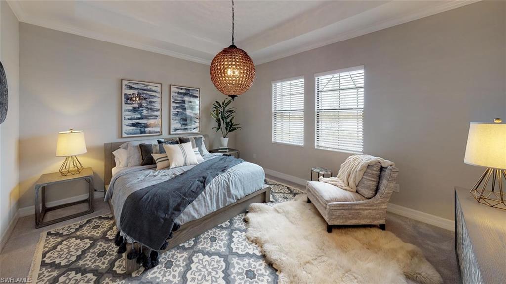 20259 Kingmont Drive Estero, FL 33928 - Photo 12 of 14 a spacious bedroom with a bed and a chandelier