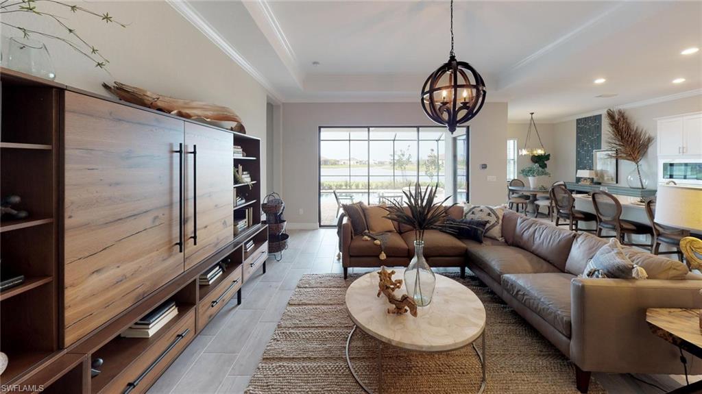 20259 Kingmont Drive Estero, FL 33928 - Photo 3 of 14 a living room with furniture a window and a chandelier