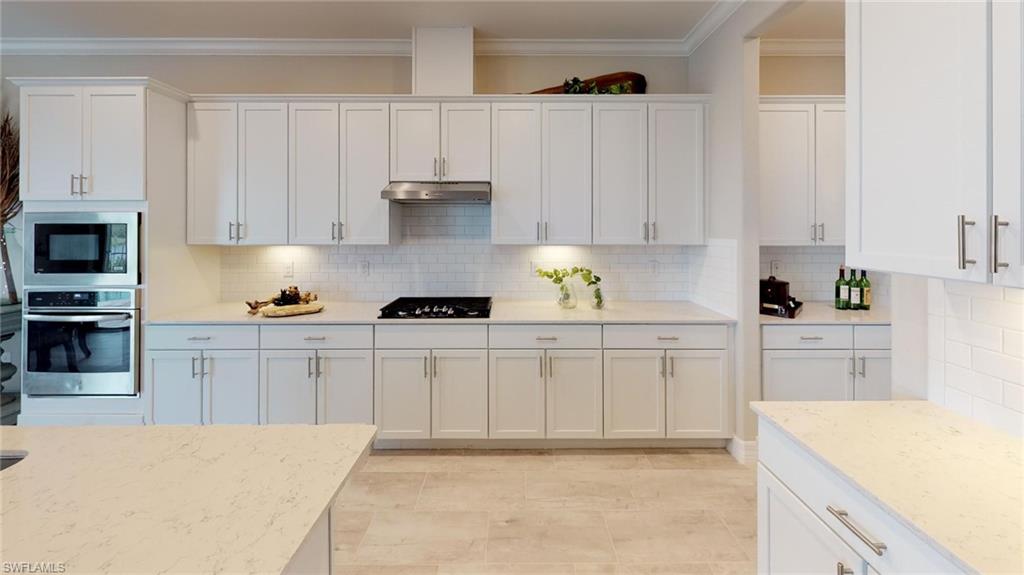 20259 Kingmont Drive Estero, FL 33928 - Photo 4 of 14 a kitchen with cabinets appliances and a counter space
