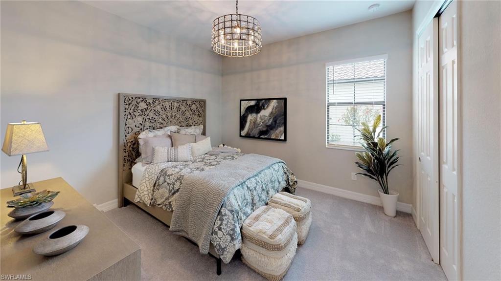 20259 Kingmont Drive Estero, FL 33928 - Photo 8 of 14 a bedroom with a bed and a chandelier