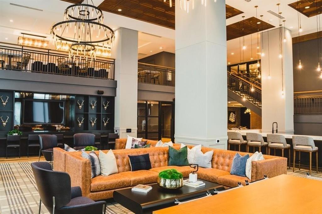 3651 Lenox Road Northeast, Unit B 05 Atlanta, GA 30305 - Photo 19 of 28 a living room with furniture a chandelier and a large window