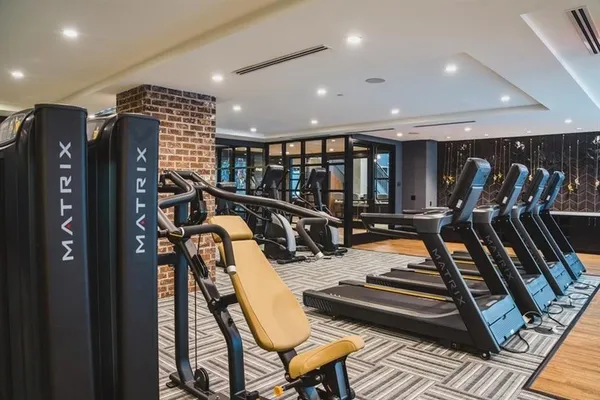 a gym room with lots of gym equipment