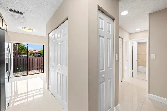 a view of a hallway with wooden floor and glass door
