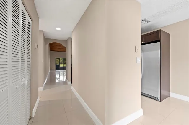 a view of hallway with livingroom and furniture