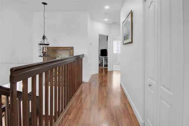 a view of hallway with wooden floor