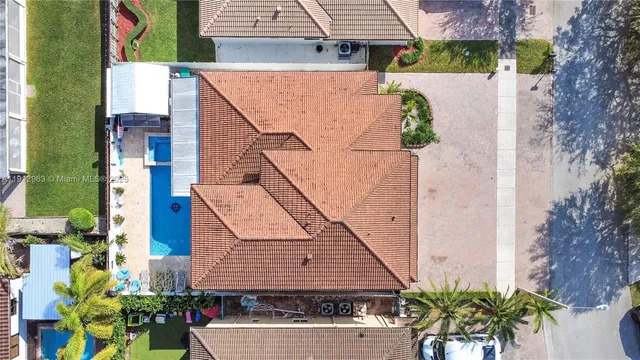 an aerial view of a house with garden space and street view