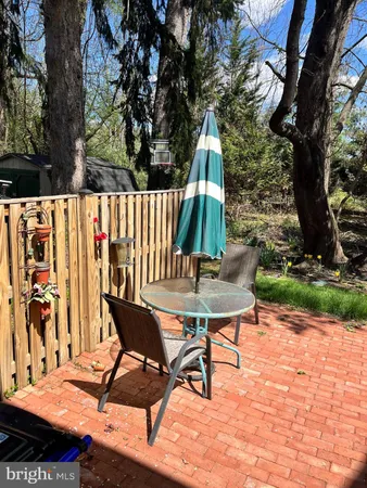 a view of a chairs and table in backyard