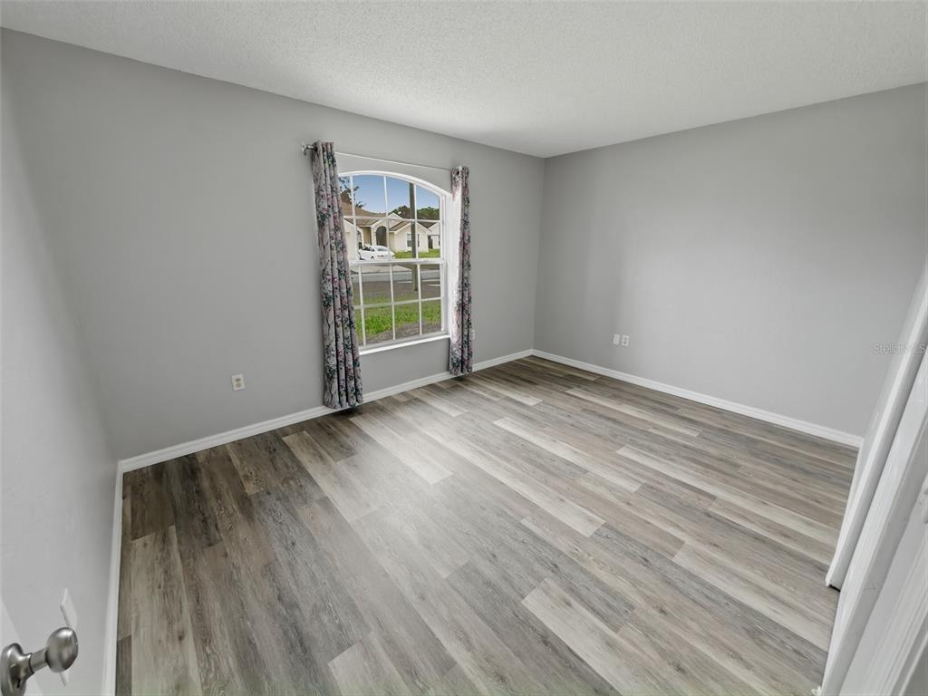 2202 Godfrey Avenue Spring Hill, FL 34609 - Photo 23 of 36 wooden floor in an empty room with a window