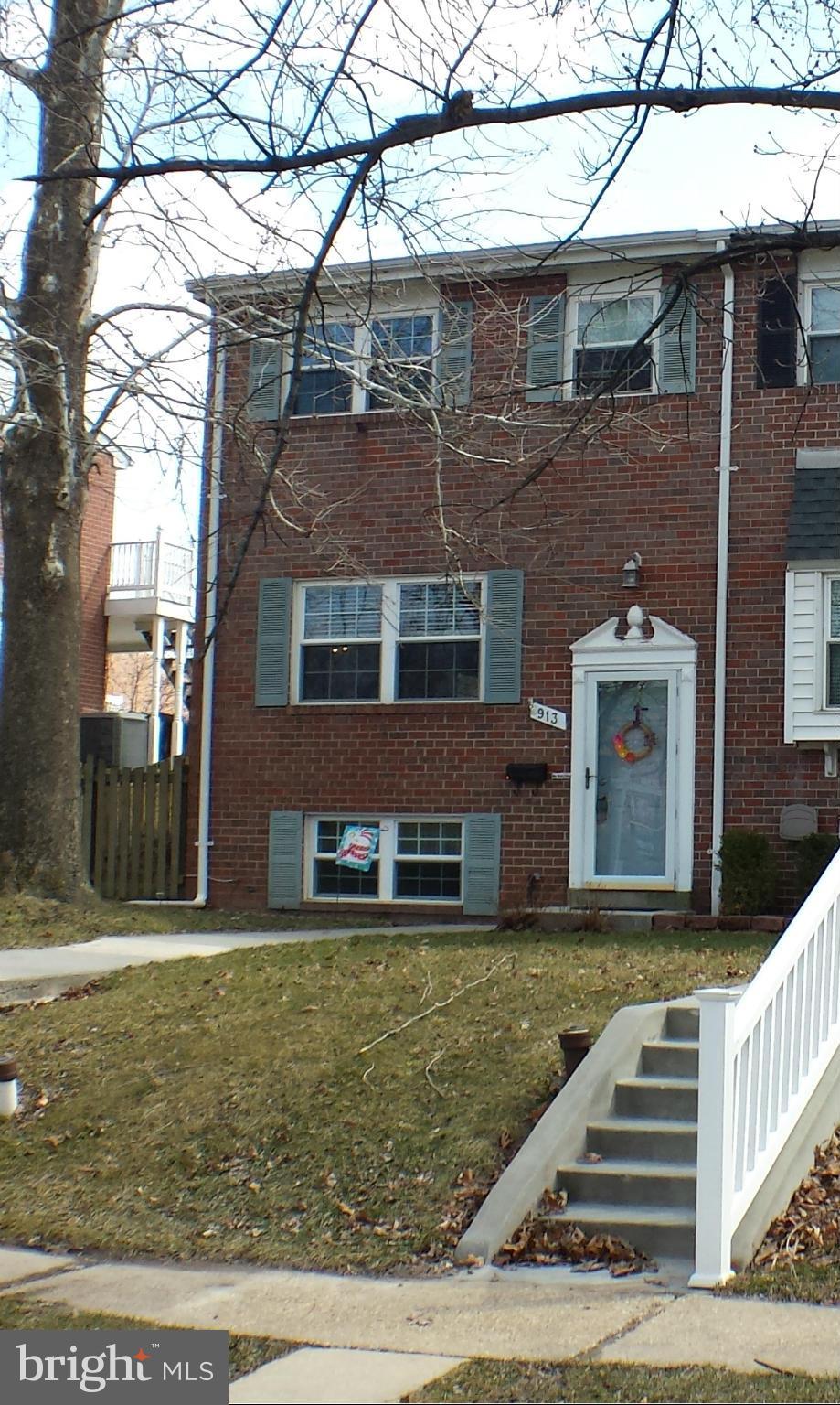 913 Elm Road Baltimore, MD 21227 - Photo 2 of 28 a front view of a house with a yard