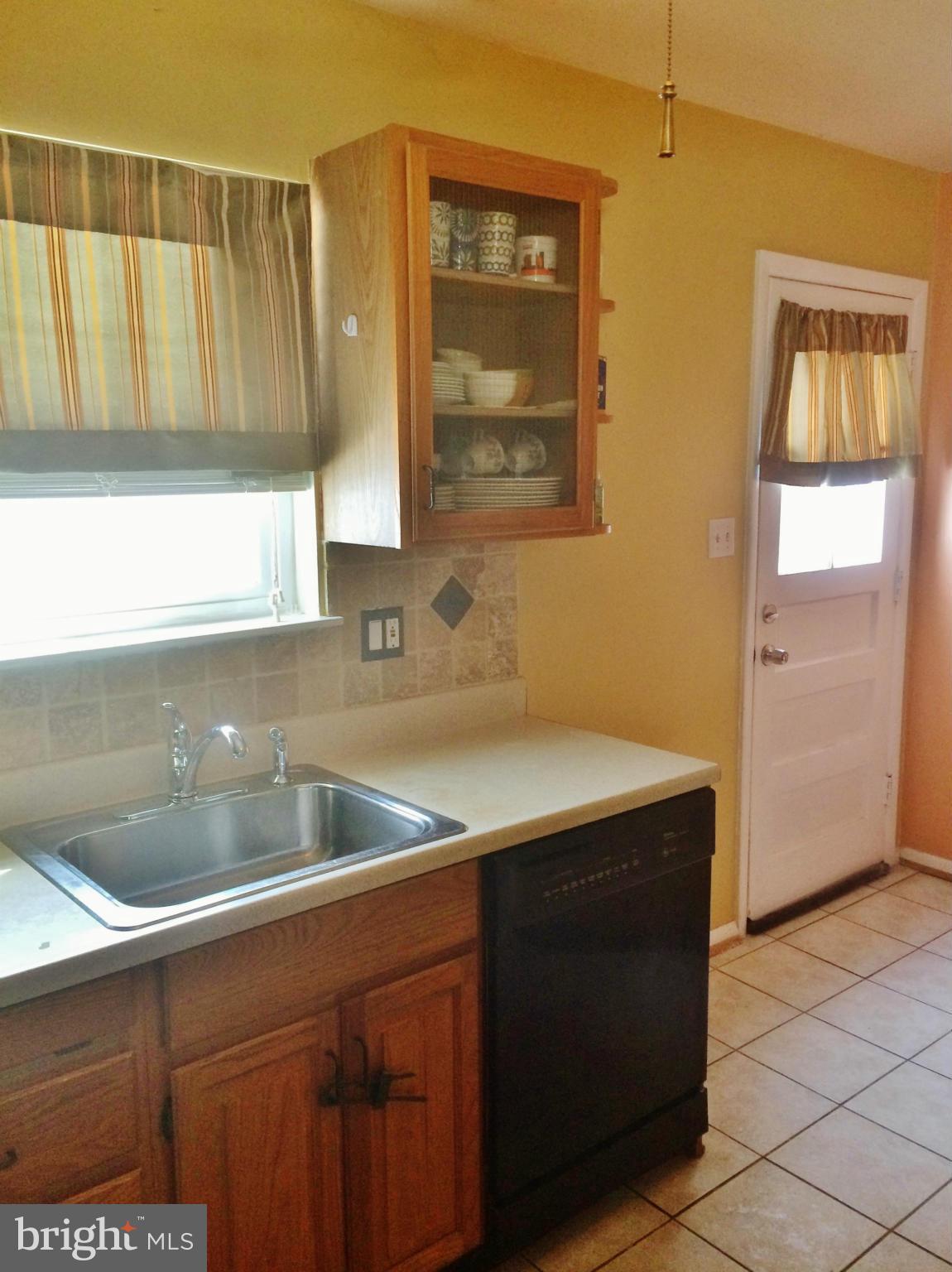 913 Elm Road Baltimore, MD 21227 - Photo 12 of 28 a kitchen with a sink and a cabinet