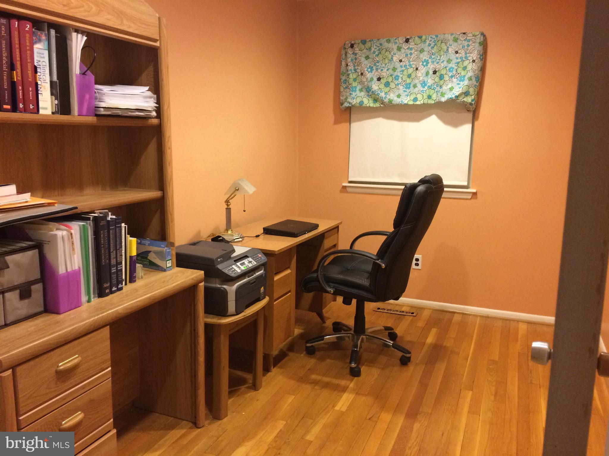 913 Elm Road Baltimore, MD 21227 - Photo 17 of 28 a view of a workspace with furniture and a book shelf