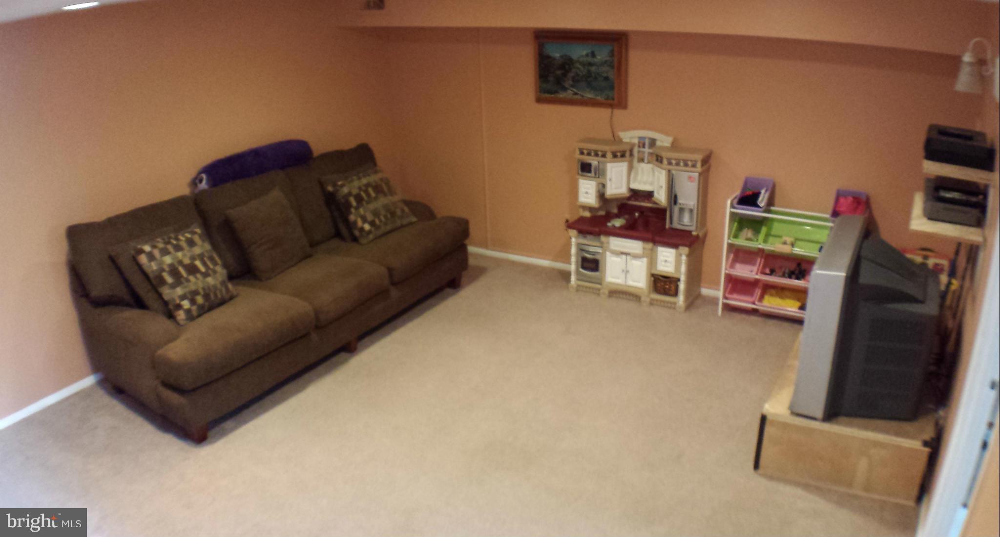913 Elm Road Baltimore, MD 21227 - Photo 23 of 28 a living room with furniture and a flat screen tv