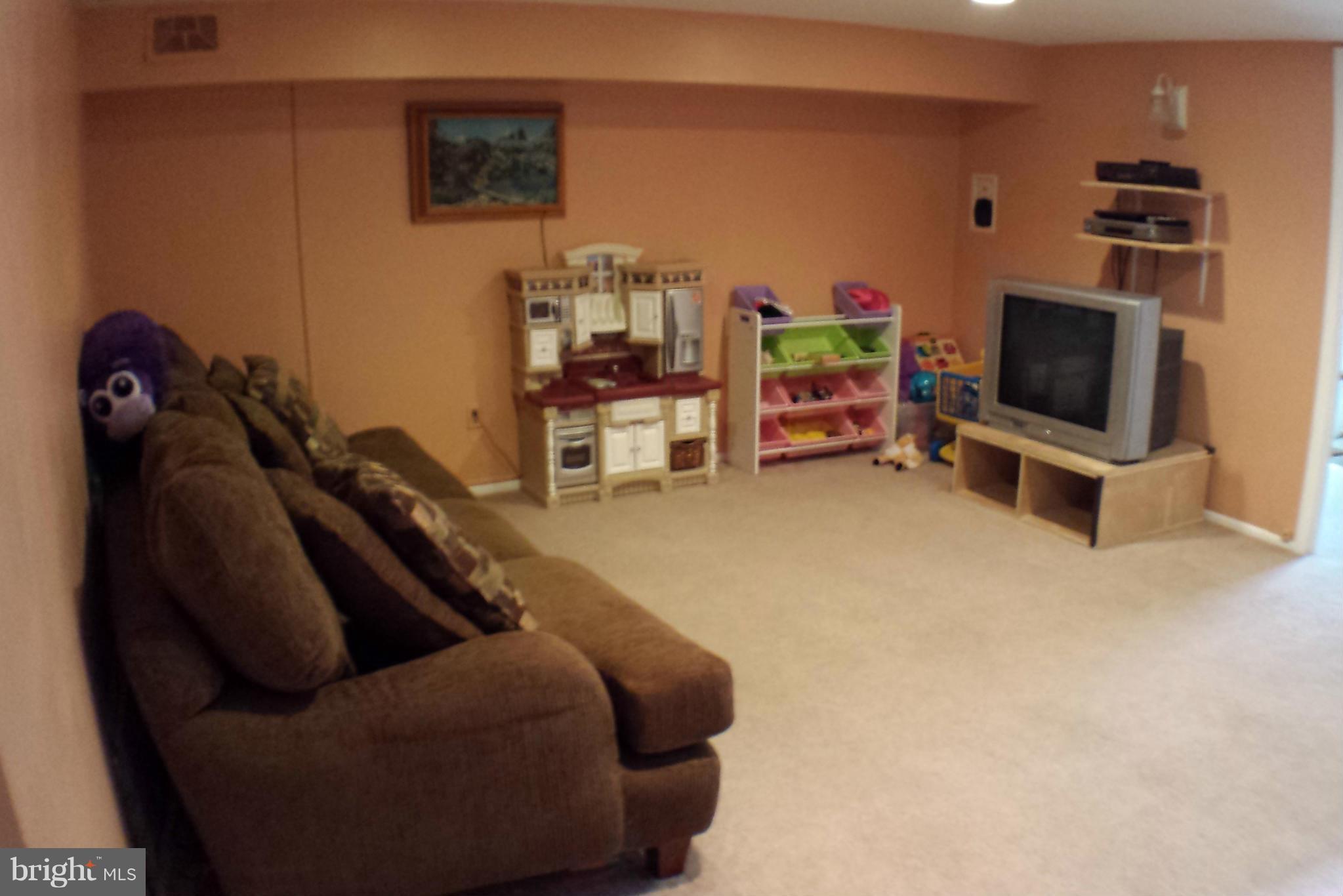 913 Elm Road Baltimore, MD 21227 - Photo 24 of 28 a living room with furniture and a flat screen tv
