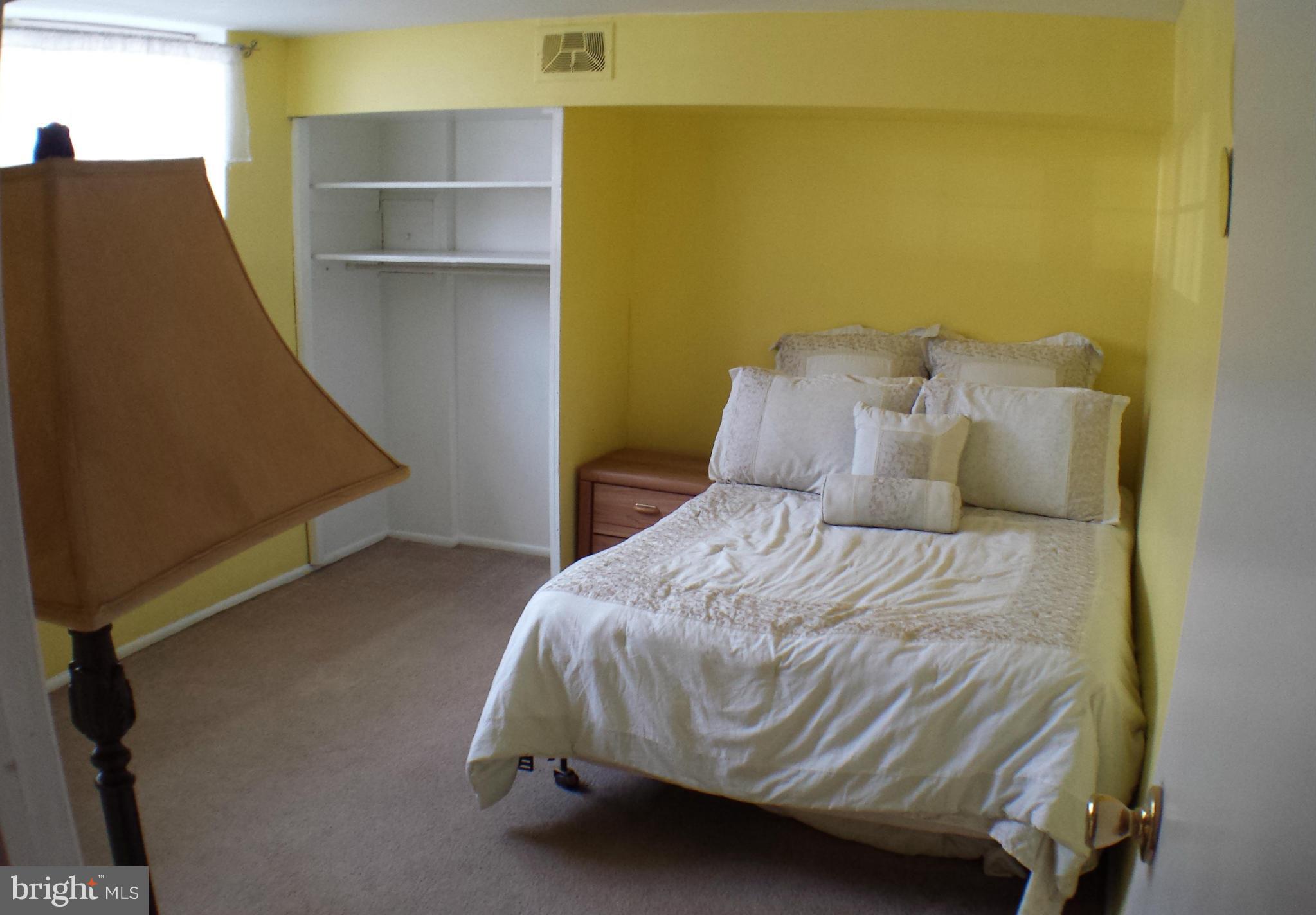913 Elm Road Baltimore, MD 21227 - Photo 25 of 28 a bedroom with a bed and a potted plant