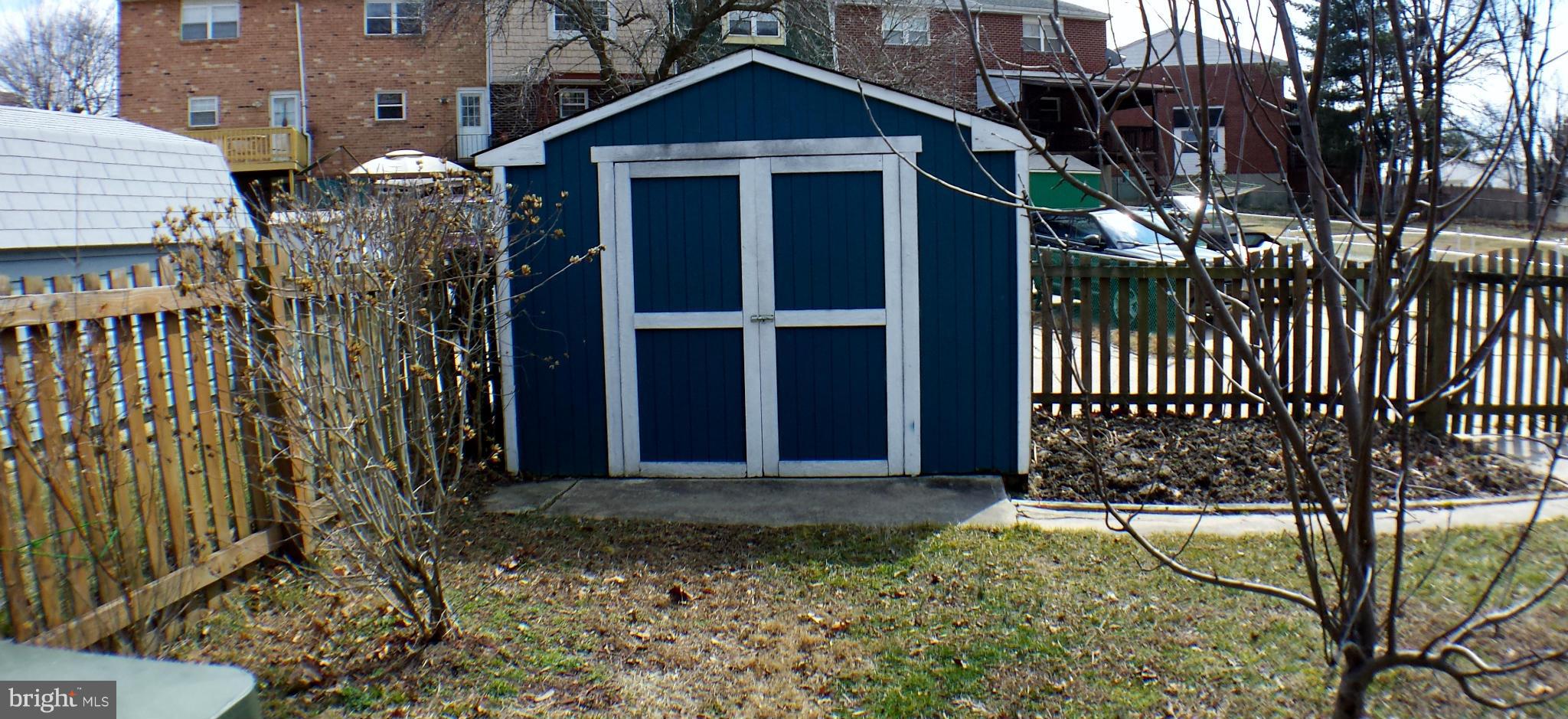 913 Elm Road Baltimore, MD 21227 - Photo 28 of 28 a view of a house with a small yard and wooden fence
