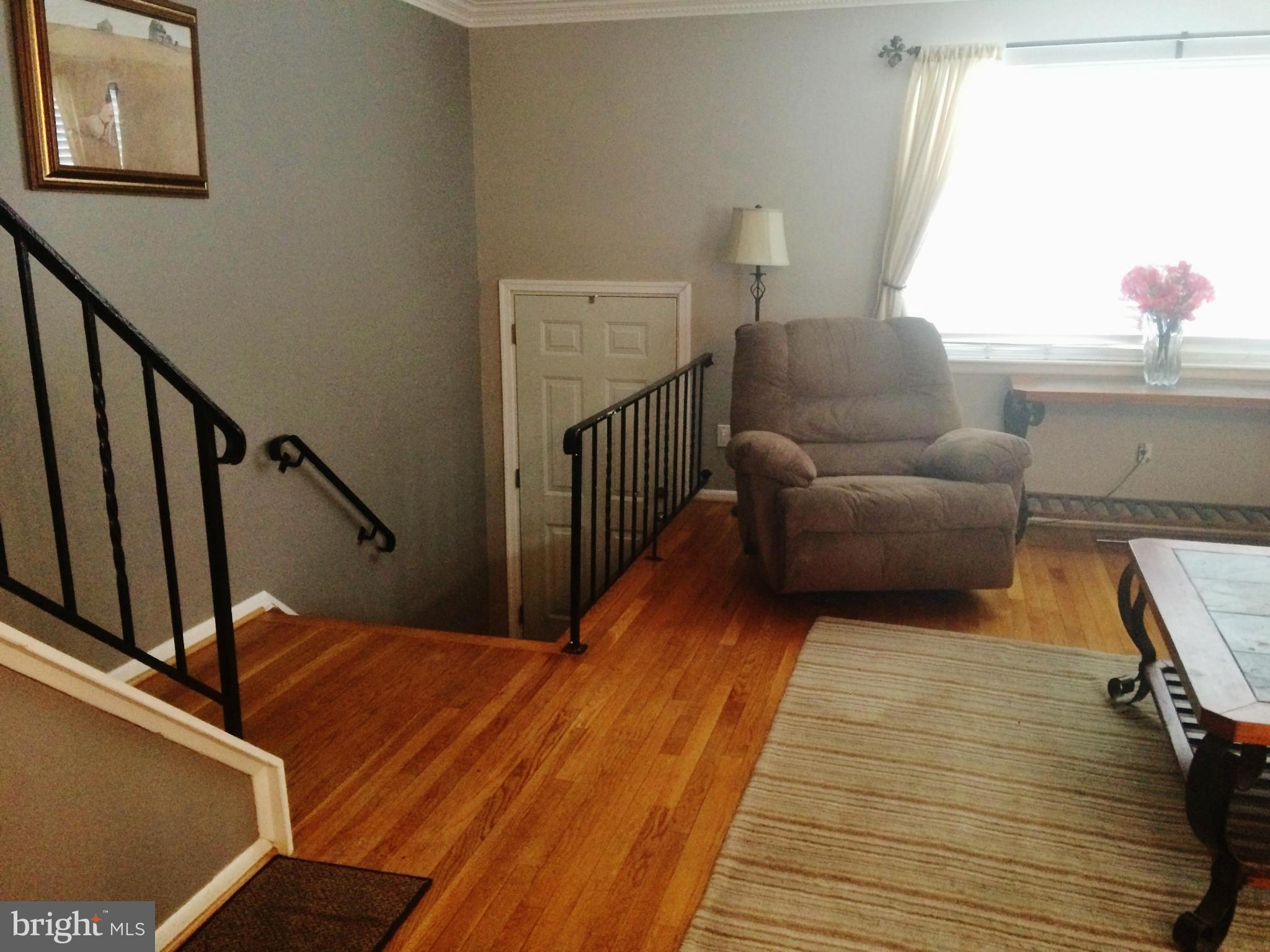 913 Elm Road Baltimore, MD 21227 - Photo 6 of 28 a living room with furniture and a wooden floor