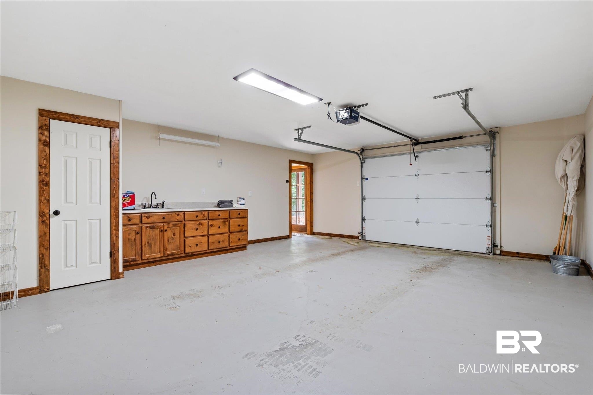2228 Riverside Drive Mobile, AL 36605 - Photo 44 of 51 Garage with a garage door opener and sink