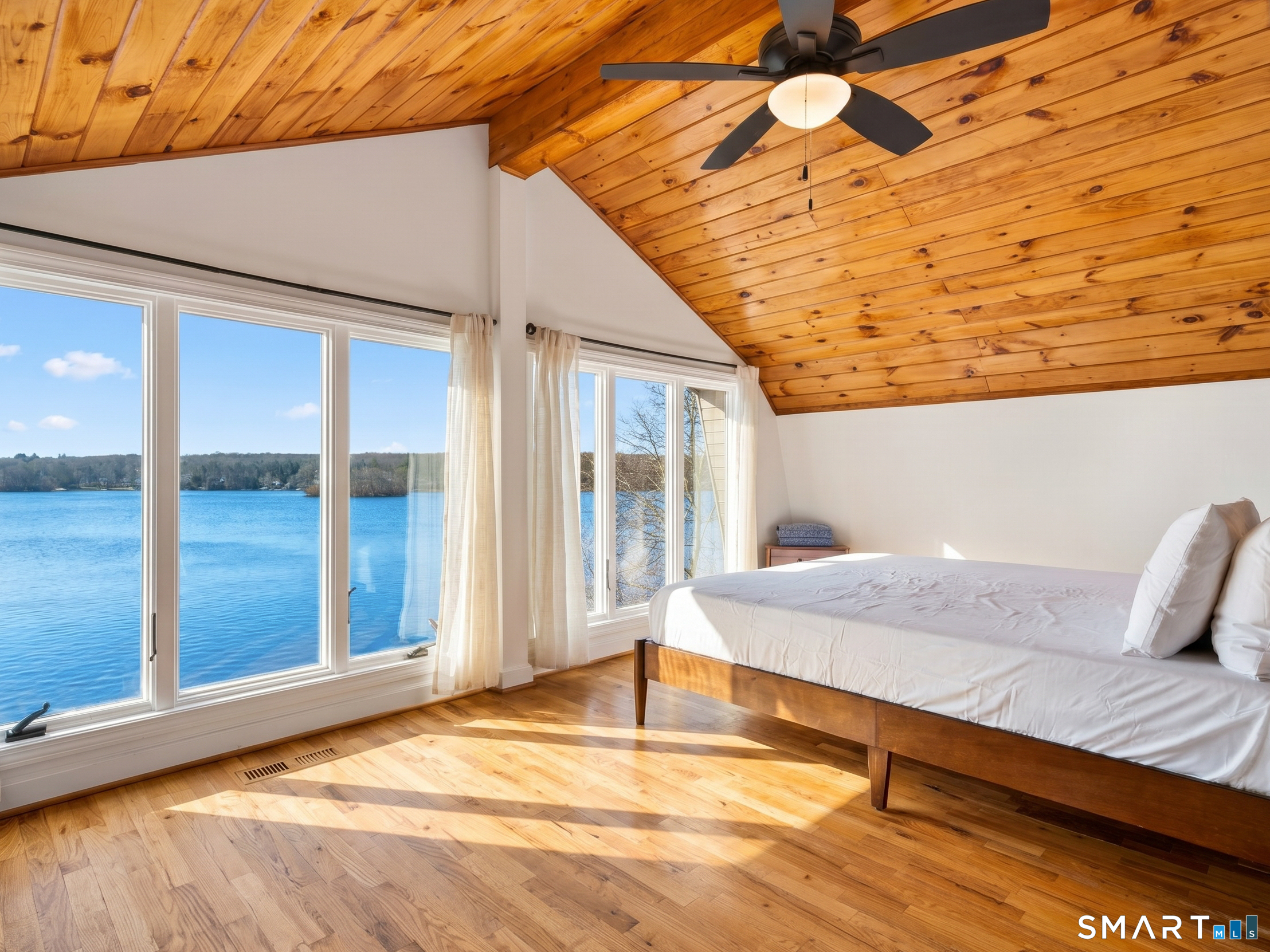 148 Old Colchester Road Salem, CT 06420 - Photo 22 of 40 Primary suite features floor to ceiling wall of windows with panoramic lake views