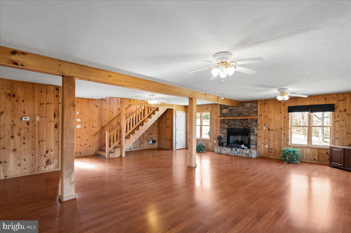 325 Coyote Run Mathias, WV 26812 - Photo 15 of 40 a view of an empty room with wooden floor and a fireplace
