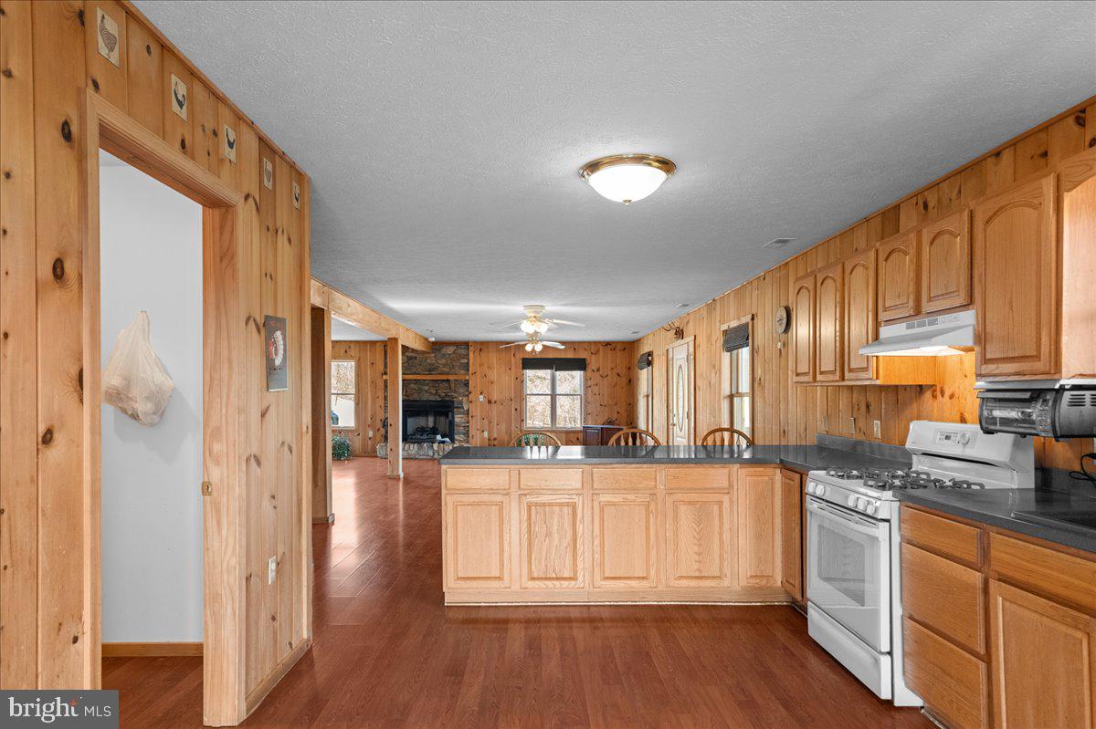 325 Coyote Run Mathias, WV 26812 - Photo 18 of 40 a kitchen with stainless steel appliances granite countertop a refrigerator a sink and white cabinets