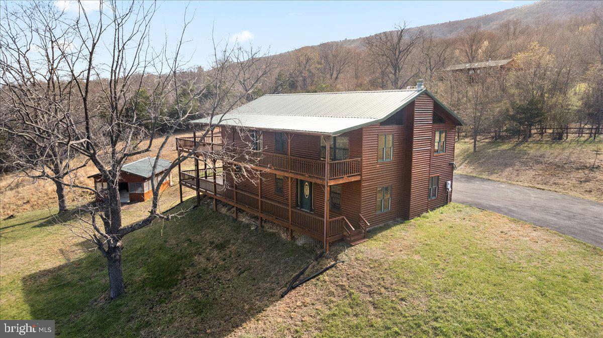 325 Coyote Run Mathias, WV 26812 - Photo 3 of 40 a view of a house with a yard and wooden fence