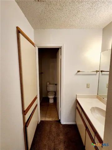 a kitchen with a sink a refrigerator and wooden floor