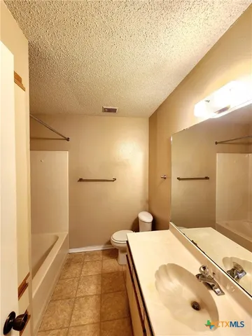 a bathroom with a bathtub and shower