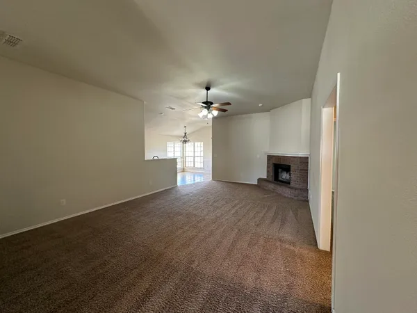 a view of a livingroom with a ceiling fan and window
