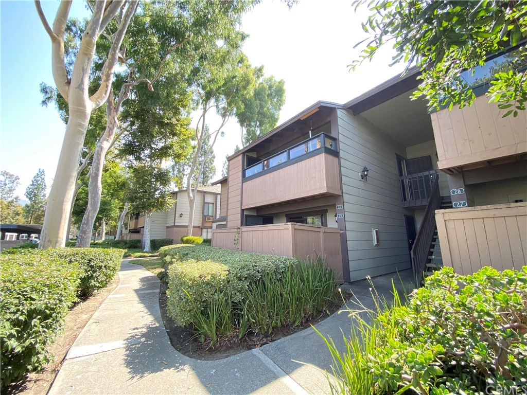 20702 El Toro Road, Unit 26 Lake Forest, CA 92630 - Photo 1 of 1 a front view of a house with garden