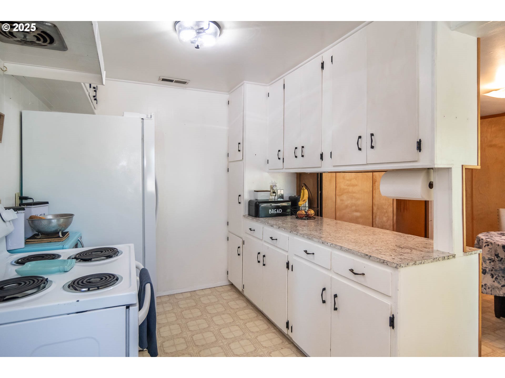 68 Rose Avenue Winston, OR 97496 - Photo 11 of 43 a kitchen with granite countertop white cabinets and white appliances